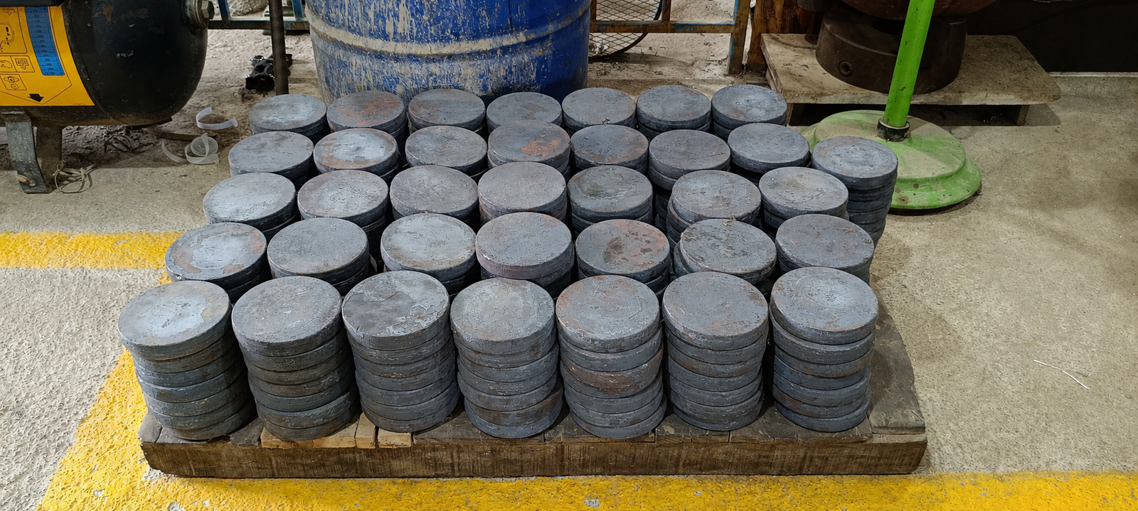 Stacked steel pipes with crane